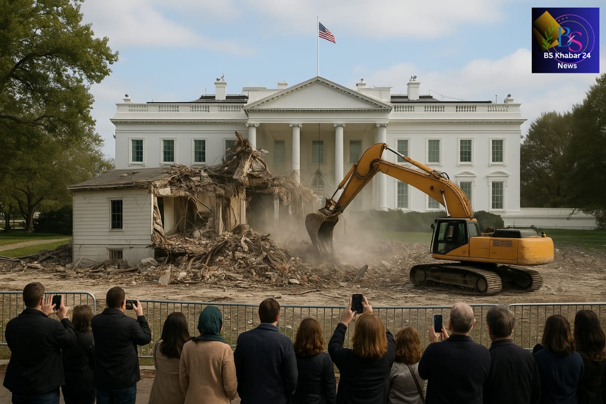 Trump East Wing Demolition, demolition crew uses heavy machinery to tear down a small structure on the White House grounds, while a group of people stand behind barricades taking photos. The main White House building stands intact in the background, and the BS Khabar 24 News logo appears in the top-right corner.